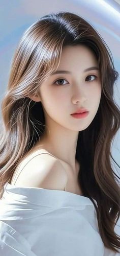 Woman with long brown hair wearing an off-shoulder top, looking at the viewer