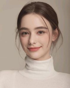 Woman with brown hair wearing a white turtleneck, smiling softly