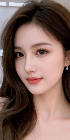 Close up portrait of a woman with long brown hair and earrings