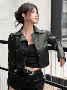 Woman in a black leather jacket and shorts with a silver belt buckle