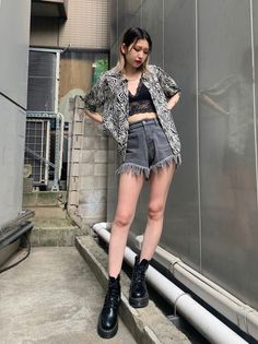 Woman in a zebra print shirt and denim shorts with a black lace bralette