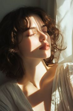 Woman with closed eyes and short curly hair bathed in warm sunlight
