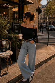 Woman in an off-shoulder top and wide-leg jeans on a sunlit street