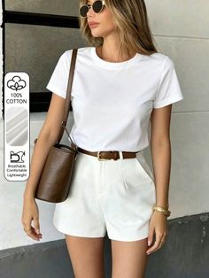 Woman in a white t-shirt and white shorts with a brown belt and sunglasses