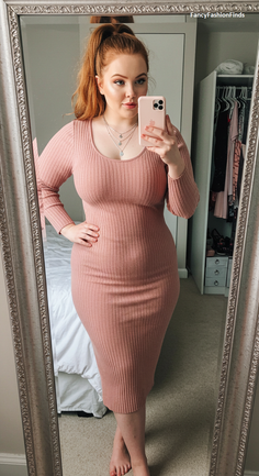 Woman in a pink ribbed dress taking a mirror selfie indoors