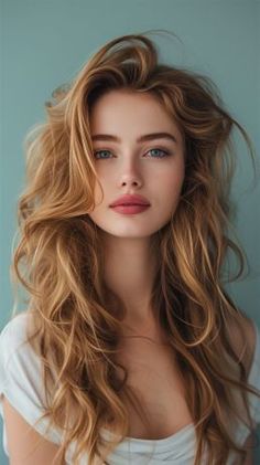 Woman with long blonde hair and blue eyes against a blue background