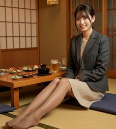 Woman in a suit jacket and skirt sitting on a tatami mat in a Japanese style room