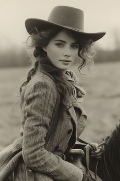 Woman in a cowboy hat and tweed coat on horseback in sepia tone