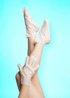 Legs and an arm with foot and hand masks against a light blue background