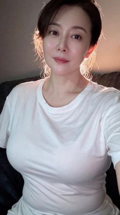 Woman in a white t-shirt with backlight on her hair