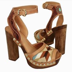 Pair of high-heeled platform sandals with wooden heels and carved leather straps