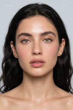 Close-up portrait of a woman with green eyes and dark hair