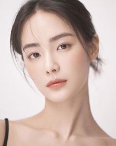 Woman with dark hair and natural makeup in a soft lighting portrait