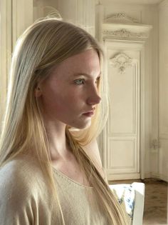 Blonde woman with long hair in soft indoor lighting