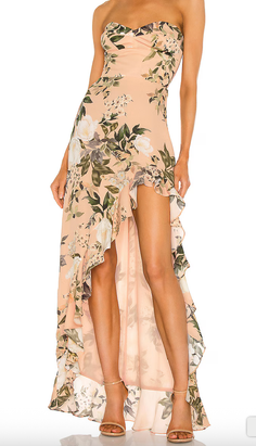 Woman in a floral strapless high-low dress with ruffle details and heels
