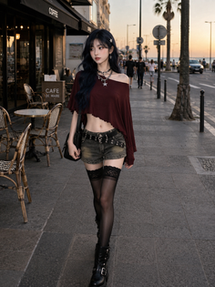 Woman with long dark hair in an off-shoulder top and denim shorts on a street