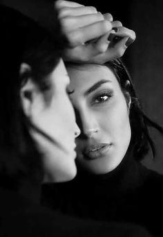 Woman in a black turtleneck with a reflection, in black and white