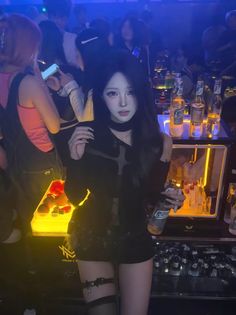 Woman in a black outfit with thigh-high stockings and garter belt in a nightclub