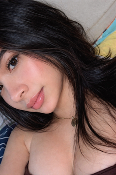 Woman with long black hair and a gold necklace, showing exposed skin