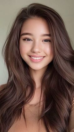 Smiling woman with long brown hair in a close-up portrait
