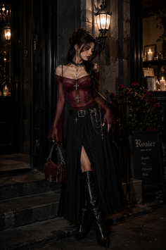Woman in gothic attire with a sheer top and long skirt at night