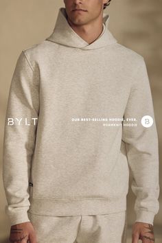 Man wearing a gray hoodie in an indoor setting
