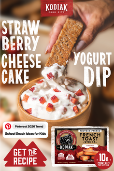 Hand dipping a french toast stick into strawberry cheesecake dip