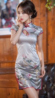 Woman in a silver floral cheongsam dress with an updo hairstyle