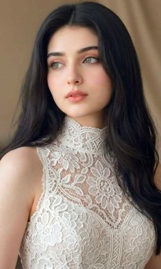 Woman with long black hair wearing a white lace high-neck top