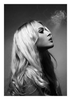 Woman with long blonde hair in profile, with smoke rising above her