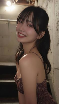 Smiling woman with long black hair in a dress indoors
