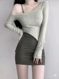 Woman in a long sleeve top and mini skirt with an exposed shoulder