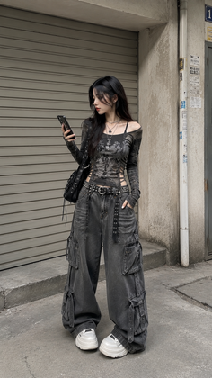 Woman in cargo pants and an off-shoulder top standing on a street
