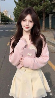 Woman with long brown hair wearing a pink cardigan and pleated skirt on a street