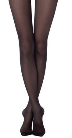 Pair of legs in black tights, crossed at the ankles, against a white background