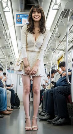 Woman in a white lace dress standing in a subway car with other passengers