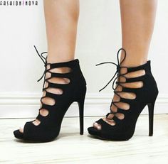 Woman wearing black lace-up peep-toe stiletto heels indoors