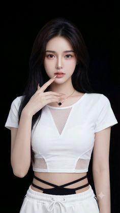 Woman with long dark hair wearing a white crop top with mesh details and a black choker