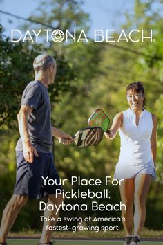 Two people playing pickleball outdoors on a sunny day