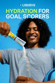 Man with curly hair pouring hydration powder into a water bottle
