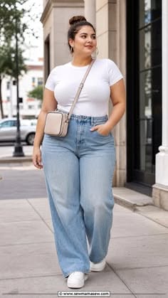 Woman in a white t-shirt and wide leg jeans walking on a street