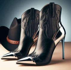 Black leather cowboy boots with silver accents and a cowboy hat