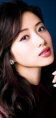 Close up portrait of a woman with long dark hair and red lipstick