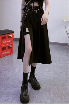 Person in a black dress with a garter belt and platform shoes