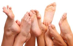 Multiple bare feet intertwined against a white background