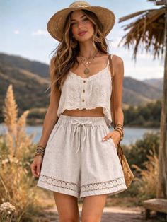 Woman in a straw hat and crop top with shorts outdoors