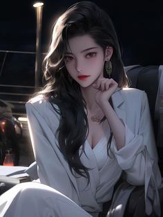 Woman with long dark hair wearing a white blazer and jewelry