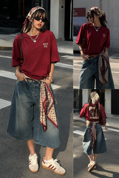 Woman in a red t-shirt, wide leg jeans, and a bandana on a street