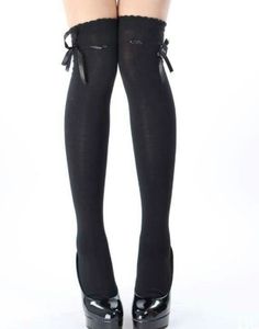 Legs wearing black thigh-high stockings with bows and black high heels