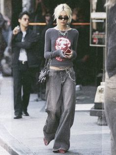 Woman with blonde hair wearing baggy jeans and a cropped top on a street